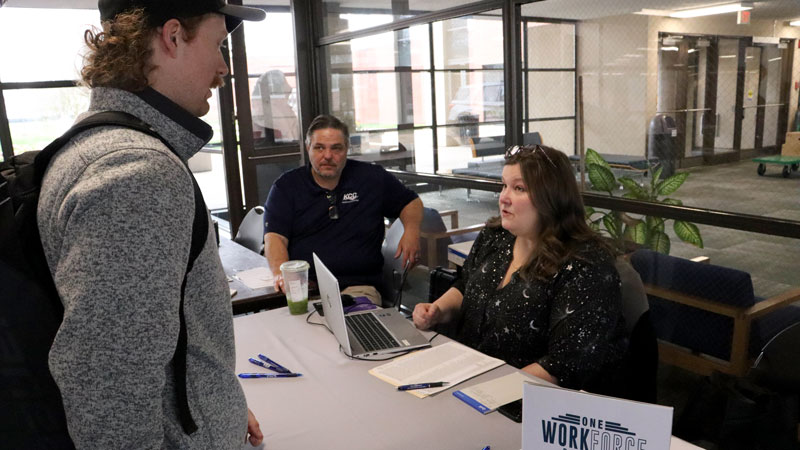 Student at a table at the KCC job fair