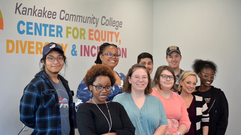 Christa Agee and eight students posing for a group photo in the Center for Equity, Diversity and Inclusion